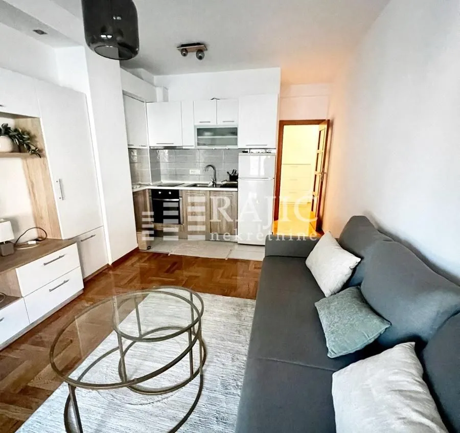 Living room connected to the kitchen in a bright interior.