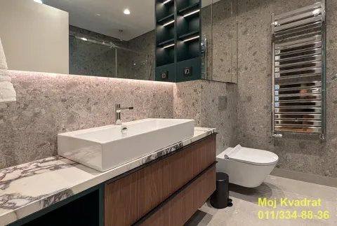Modern bathroom equipped with a washbasin, built-in cabinetry, and sanitary ware. - image 12