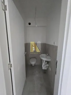 Small bathroom with a sink and toilet during finishing works. - image 14