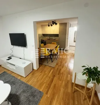 Living room with a view of the dining area and kitchen. - image 2