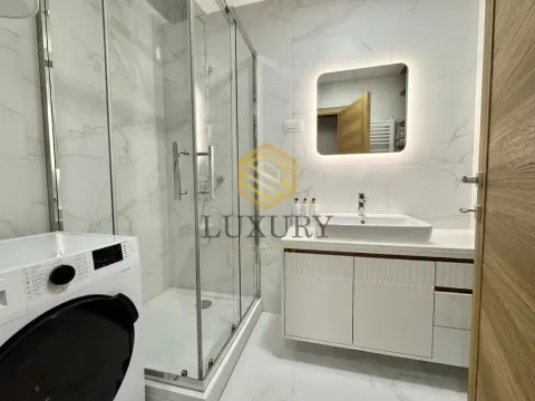 Modernly equipped bathroom with a walk-in shower and vanity unit. - image 7