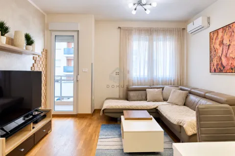 Dnevna soba sa ugaonom garniturom, televizorom i izlazom na balkon. - image 3