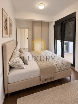 Modern bedroom with a double bed, wardrobe, and terrace access. - image 5