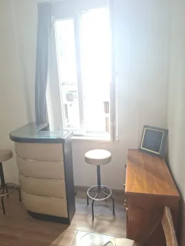 Small space with a bar counter, bar stools, and a window letting in plenty of light. - image 6