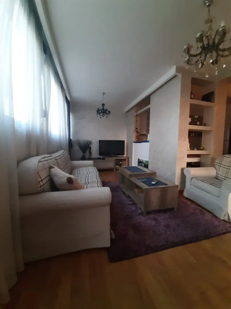 Living room with a sofa set, rug, and coffee table.