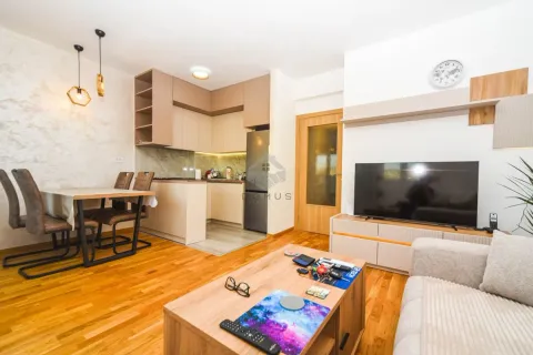 Open-plan living room with dining area and kitchen. - image 2