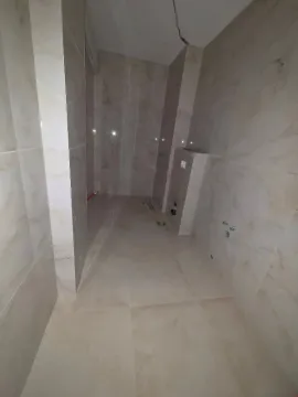 Bathroom tiled in ceramic under construction with installed plumbing. - image 7