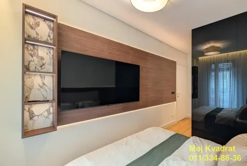 Modern bedroom with a wood-paneled feature wall and a wall-mounted TV. - image 7