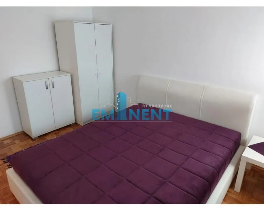 Bedroom with a double bed and white wardrobes.