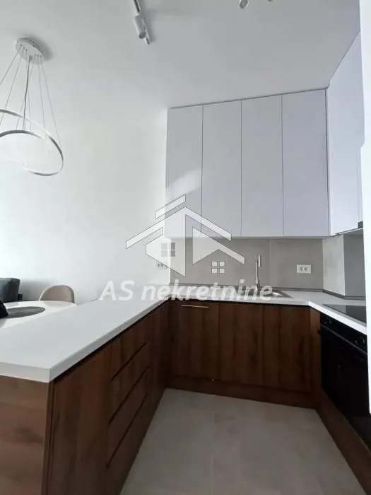 Modern kitchen with white upper and dark wooden lower cabinets.