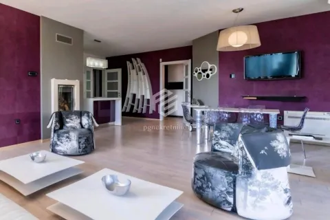 Spacious living room with modern furniture and purple walls. - image 14