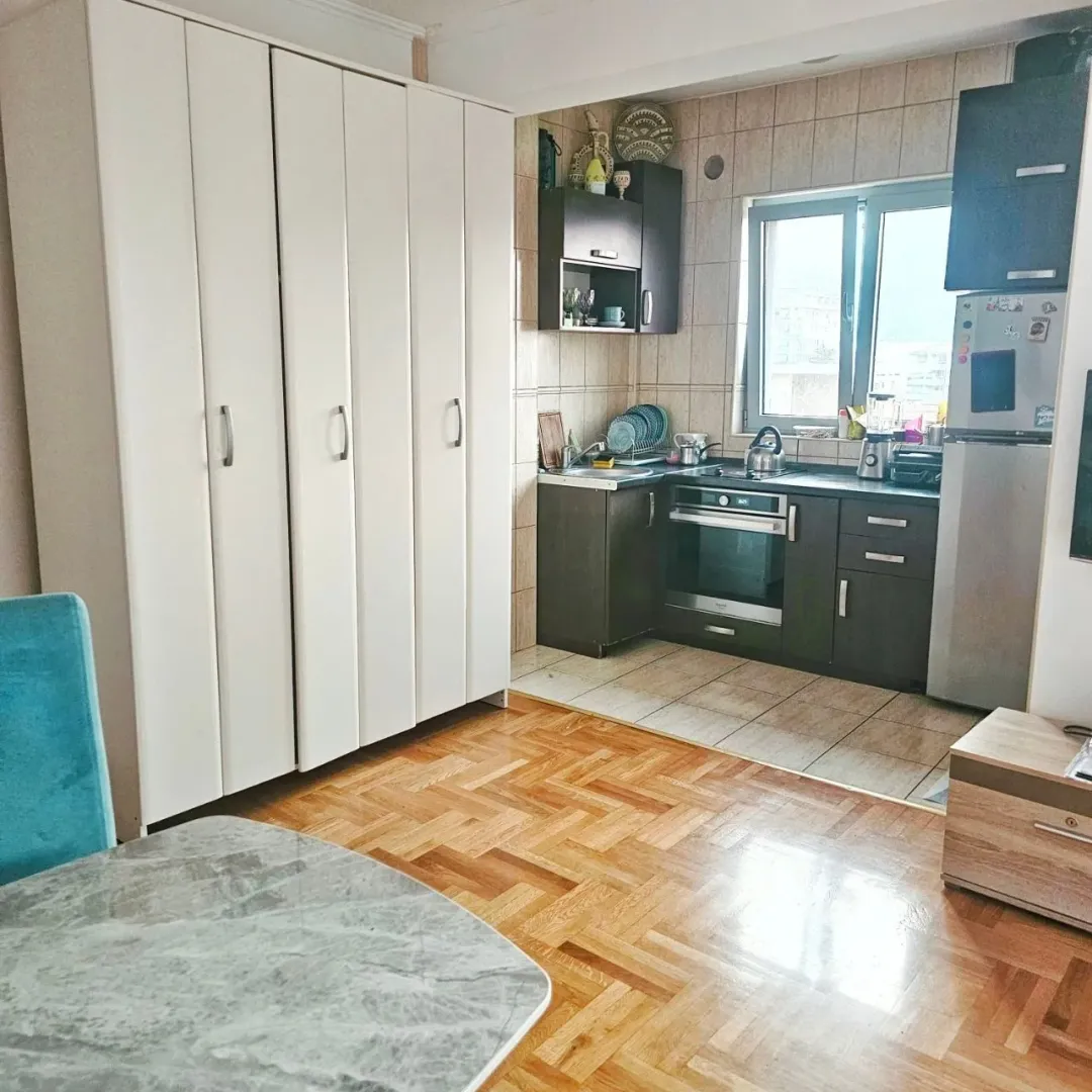 Small kitchen with dark cabinets and an adjoining dining area.