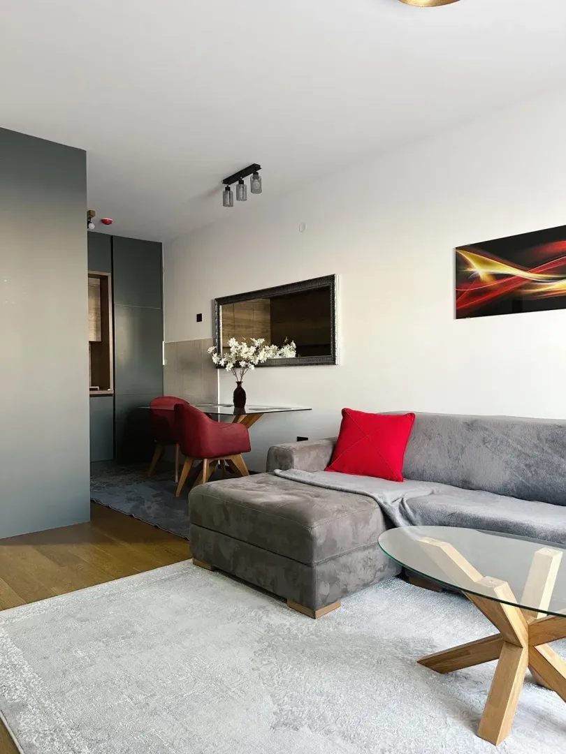 Modern living room with a sofa set and dining area.