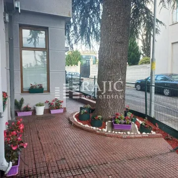 Building exterior with a landscaped yard and pathway. - image 4