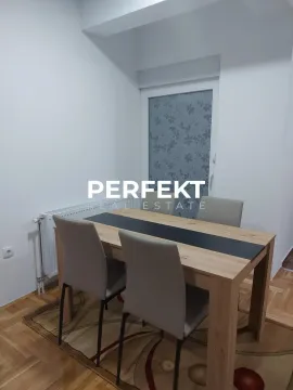 Dining area with a wooden table and modern chairs. - image 7