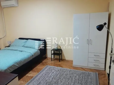 Furnished bedroom with a double bed, wardrobe, and rug. - image 6