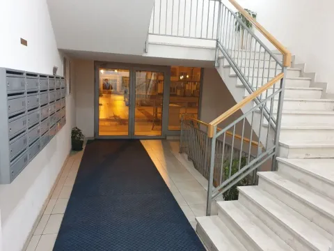 Bright entrance hall of the building with a staircase and mailboxes. - image 10