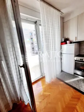 Small kitchen with white cabinets and access to the terrace. - image 9