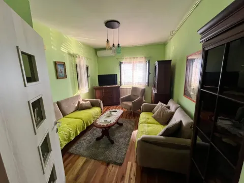 Living room with sofas, an armchair, a coffee table, and a TV. - image 5