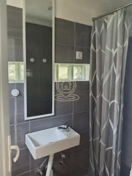Smaller bathroom with a washbasin, mirror and shower cabin. - image 4
