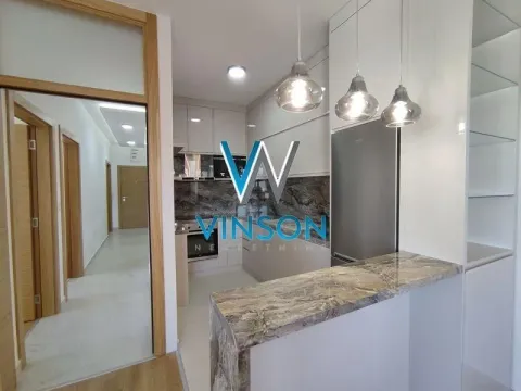 Modern kitchen with a bar counter and built-in appliances. - image 6