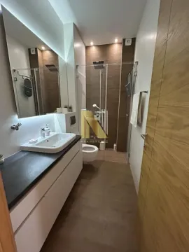 Modern bathroom equipped with a walk-in shower and washbasin. - image 9