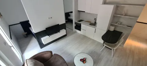 High-angle view of a bright living room with a kitchen and dining area. - image 4