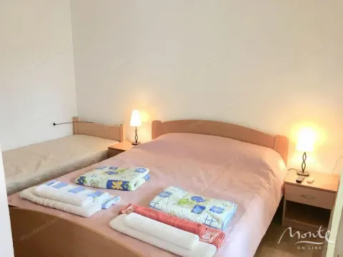Bedroom with a double bed, an extra bed, and bedside tables. - image 10