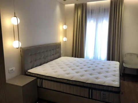 Bright bedroom with a large double bed and modern lighting. - image 3