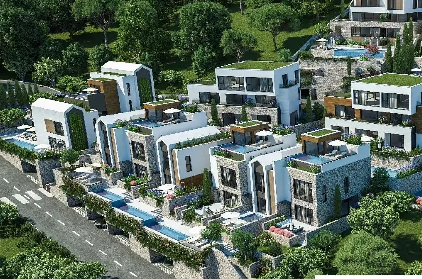 Pogled iz ptičje perspektive na kompleks modernih vila sa bazenima i zelenilom.