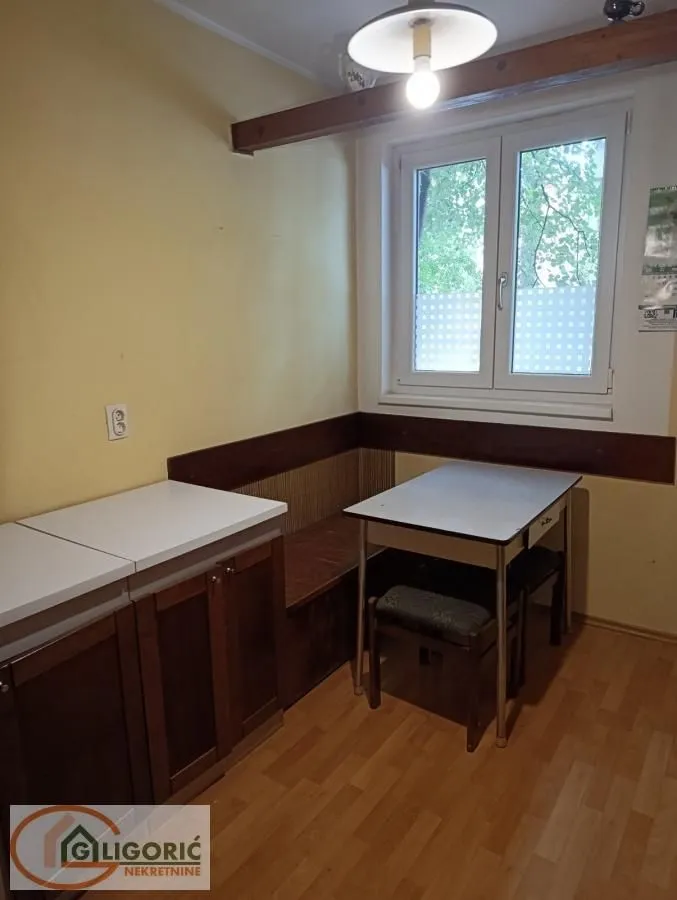 Small kitchen with a dining table and a corner bench by the window.