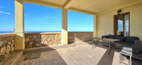 Spacious covered terrace with seating furniture and a sea view. - image 6