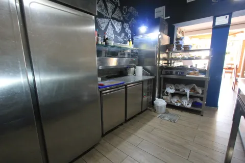 Commercial kitchen with stainless steel elements and refrigeration units. - image 20