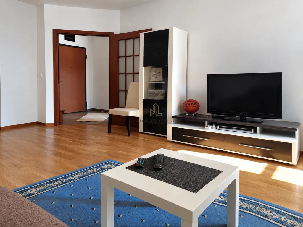 Living room with a sofa, TV, and coffee table.