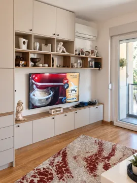 Living room with built-in cabinetry, television, and access to the terrace. - image 3
