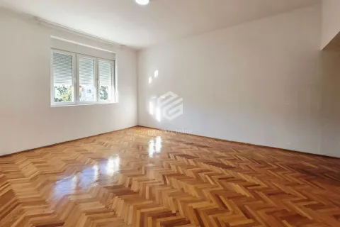 Empty room with parquet flooring and a window. - image 15