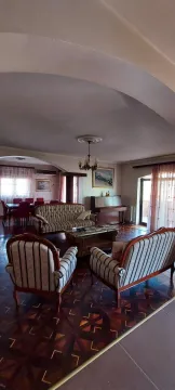 Spacious living room with classic furniture and a piano. - image 10