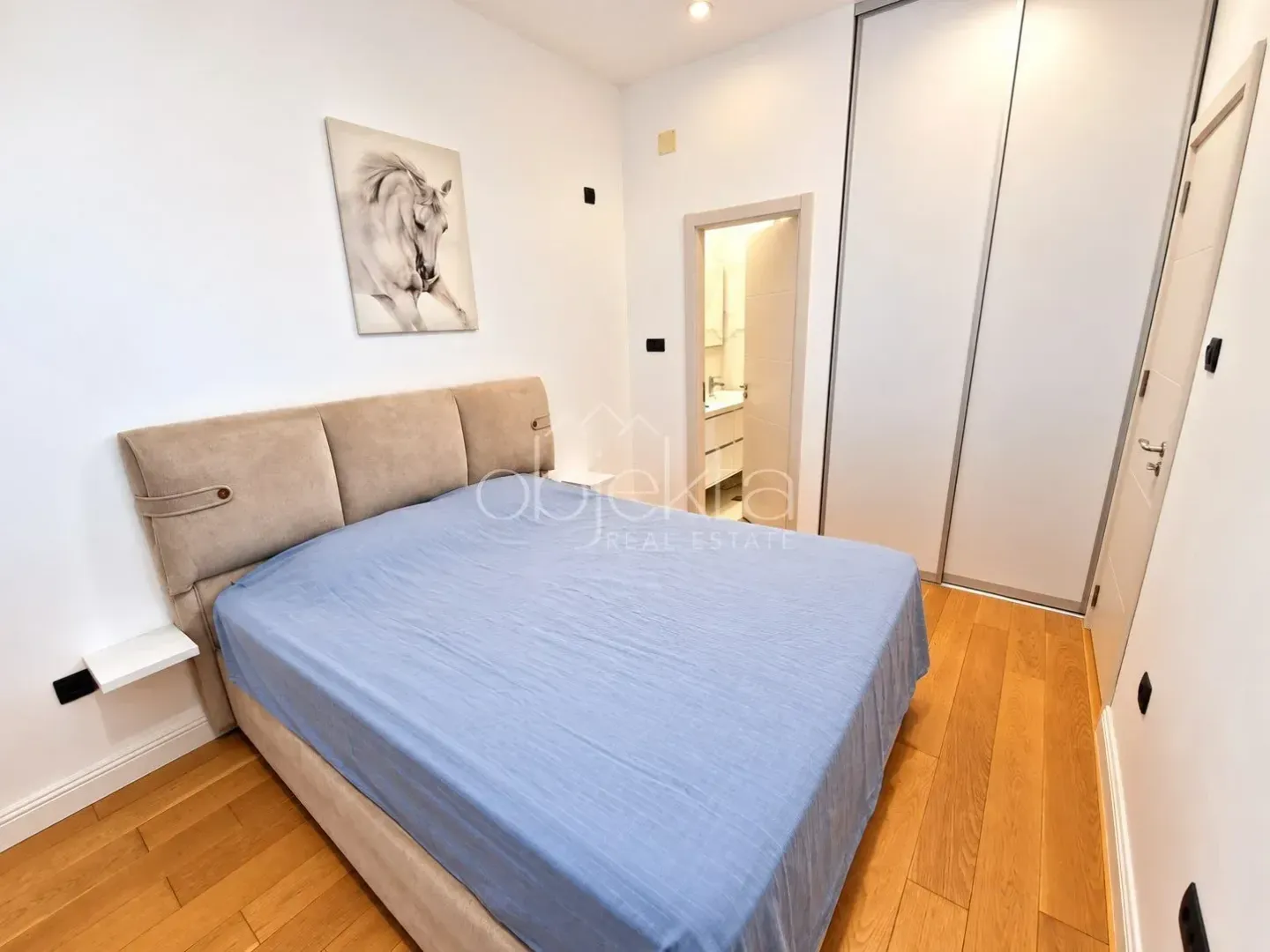 Furnished bedroom with a double bed, wardrobe, and en-suite bathroom.