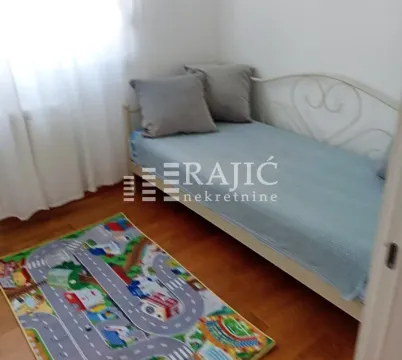 Children's bedroom with a bed and a street-motif rug. - image 10