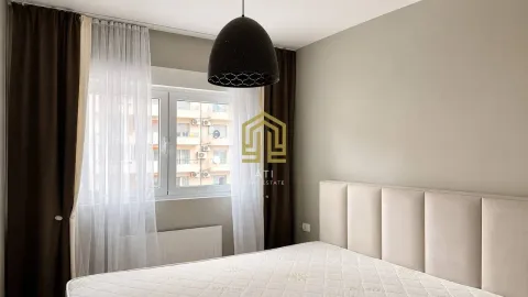 Bedroom with a large window and a bed. - image 8