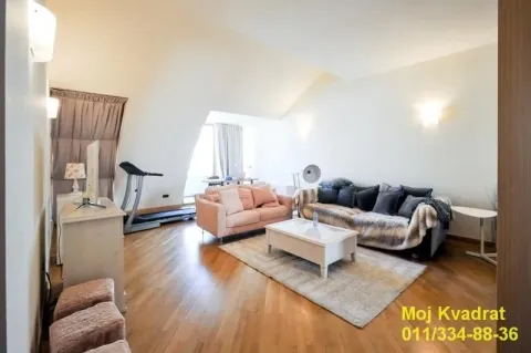 Living room with sofas, a coffee table, and an exercise machine. - image 4