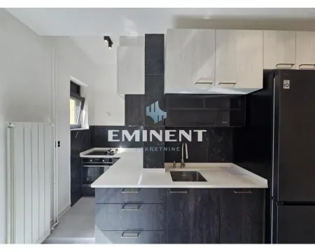 Modern kitchen with white upper cabinets and dark lower cabinets. - image 5