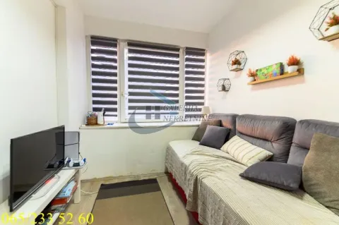 Manja dnevna soba sa ugaonom garniturom, televizorom i prozorom sa roletnama. - image 10
