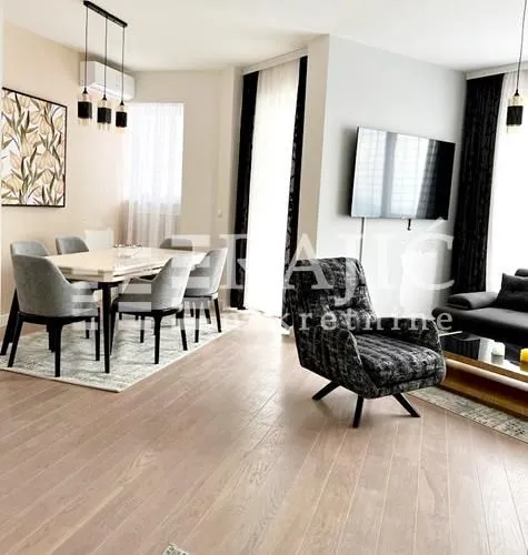 Living room with dining area and modern furniture.