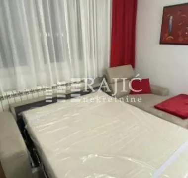 Living room with a bed and sofa. - image 3