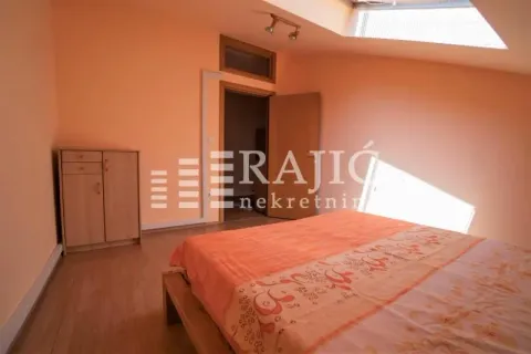 Attic bedroom with a double bed and a wooden chest of drawers. - image 3