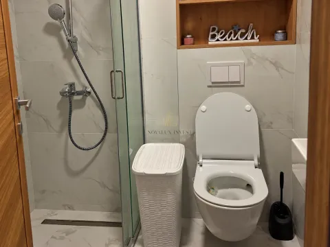 Modernly equipped bathroom with a shower cabin and a toilet. - image 7