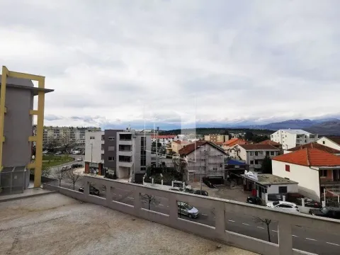 View from the terrace overlooking surrounding buildings and the cityscape. - image 11