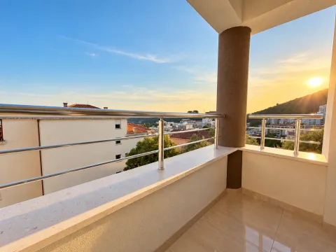 Spacious balcony with a view of the city and hills. - image 7