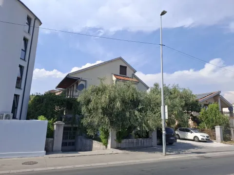 Exterior view of the house with a courtyard and greenery. - image 3